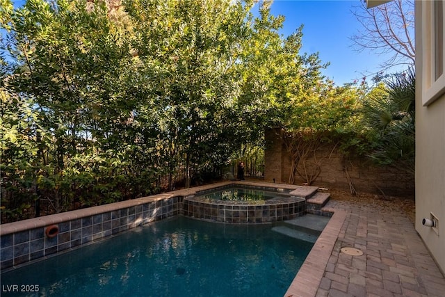 view of swimming pool featuring an in ground hot tub