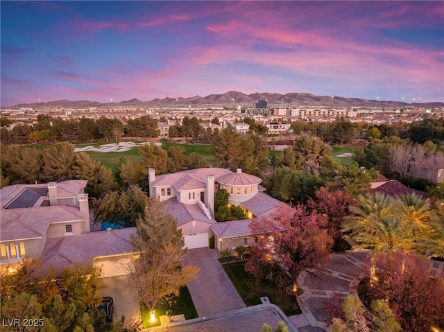 aerial view at dusk featuring a mountain view