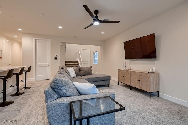 carpeted living room featuring ceiling fan