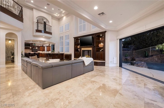 living room with crown molding and a high ceiling