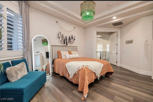 bedroom with crown molding and dark wood-type flooring