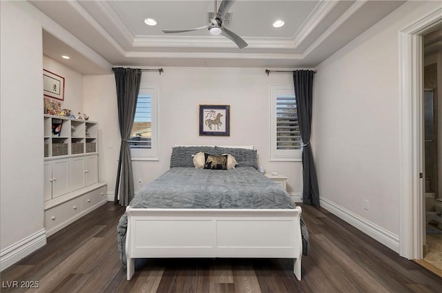 bedroom with a tray ceiling, ceiling fan, dark hardwood / wood-style floors, and ornamental molding