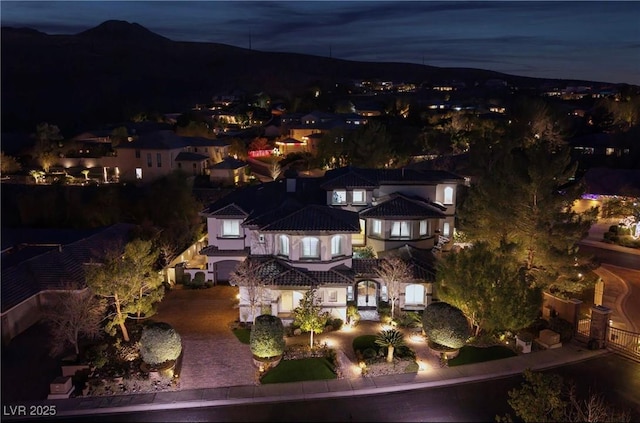 aerial view at night featuring a mountain view