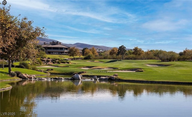 view of home's community featuring a yard and a water and mountain view