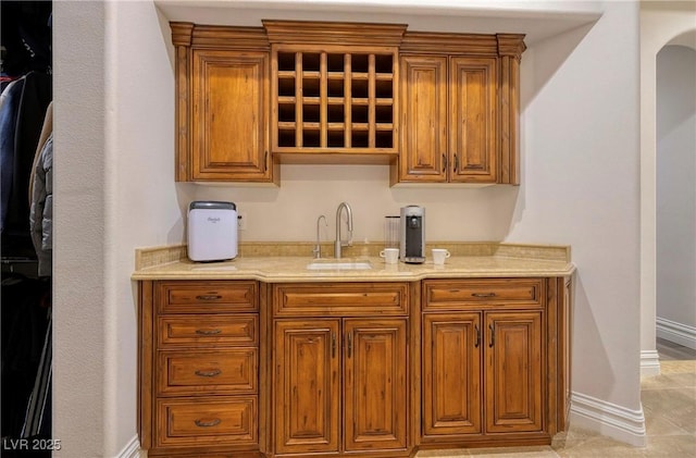 bar featuring sink and light tile patterned flooring