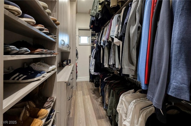 spacious closet featuring light hardwood / wood-style floors