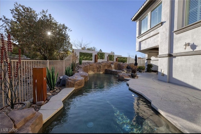 view of pool with pool water feature