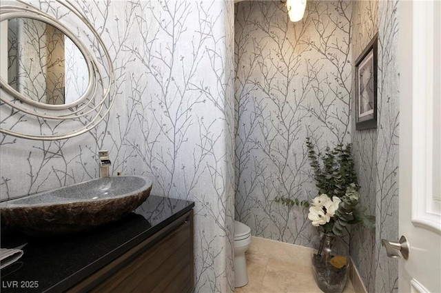 bathroom featuring tile patterned flooring, vanity, and toilet