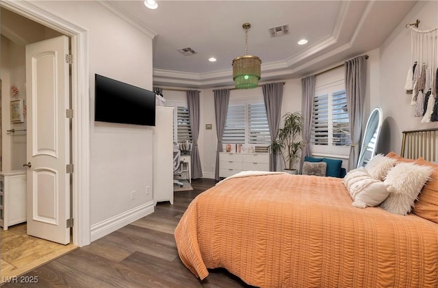 bedroom featuring a tray ceiling, crown molding, and dark hardwood / wood-style floors