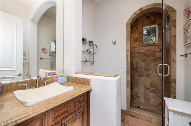 bathroom with vanity and a shower with shower door