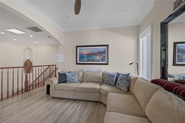 living room with visible vents, ornamental molding, light wood-style flooring, and recessed lighting