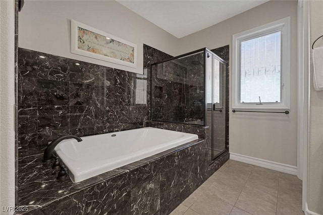 full bathroom with tile patterned flooring, a marble finish shower, baseboards, and a tub with marble appearance