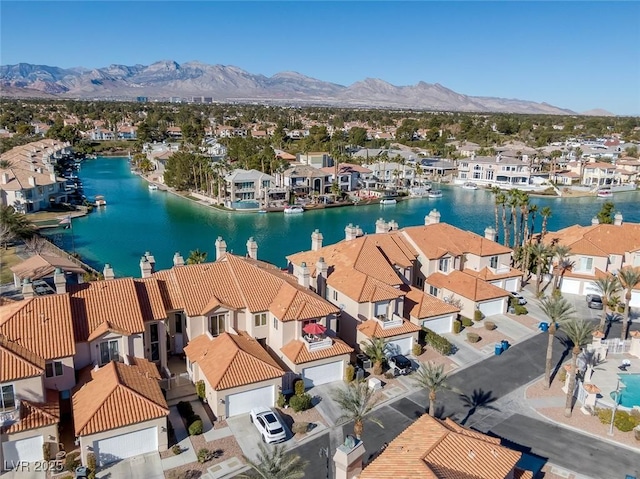 drone / aerial view with a residential view and a water and mountain view