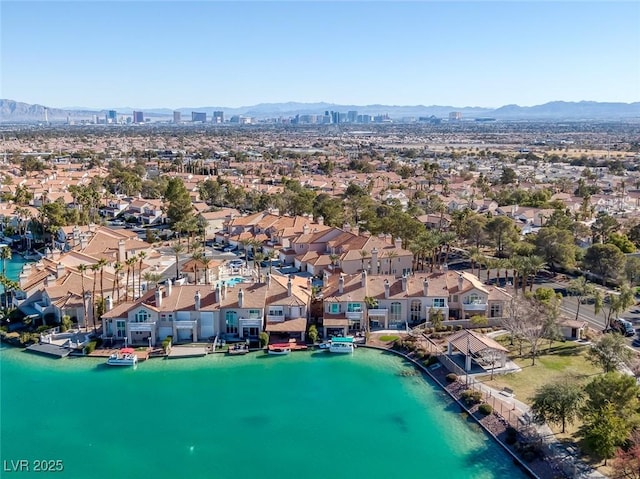 birds eye view of property featuring a residential view and a water and mountain view