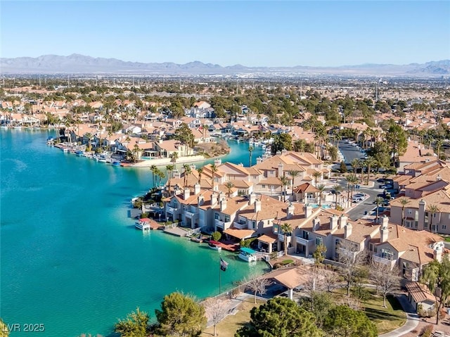 drone / aerial view featuring a residential view and a water and mountain view