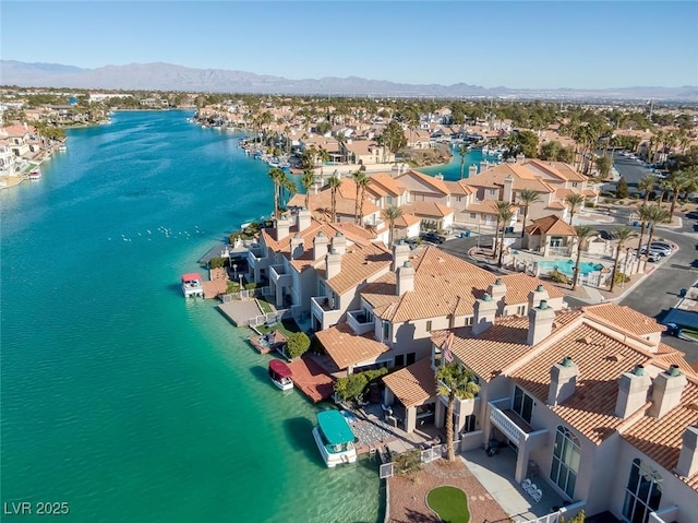 drone / aerial view with a residential view and a water and mountain view