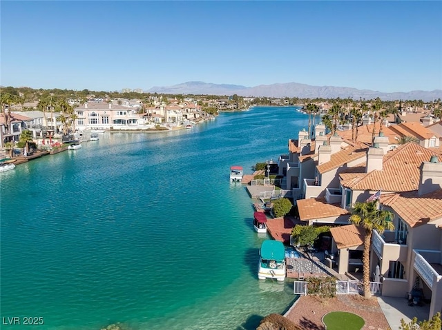 drone / aerial view with a residential view and a water and mountain view