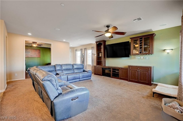 living room featuring light carpet and ceiling fan