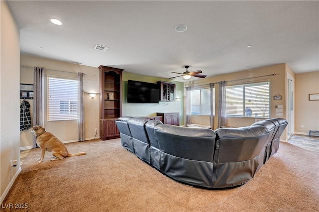 living room with ceiling fan and light colored carpet