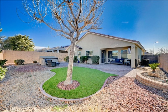 back of house featuring a patio area, an outdoor hangout area, and a hot tub