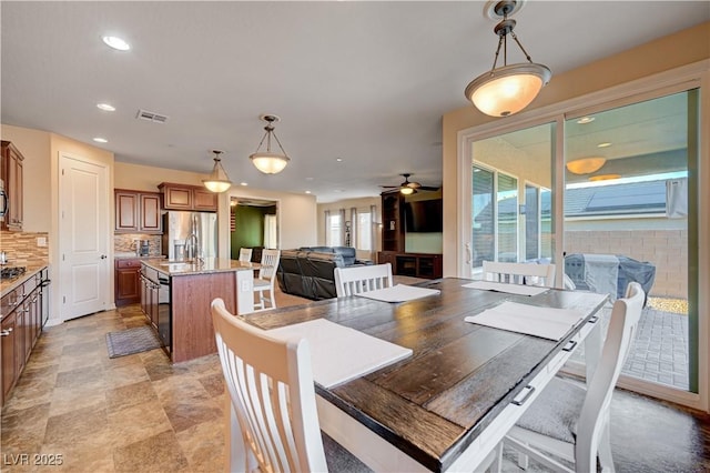 dining room featuring ceiling fan