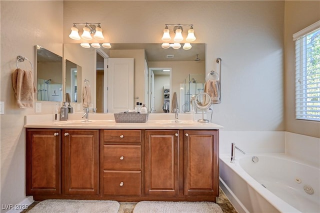 bathroom featuring vanity and shower with separate bathtub