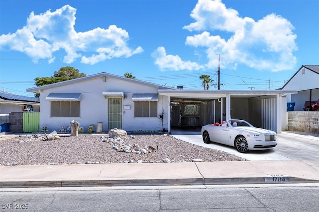 view of front of property featuring a carport