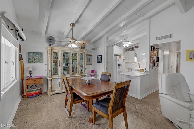 dining area with vaulted ceiling with beams