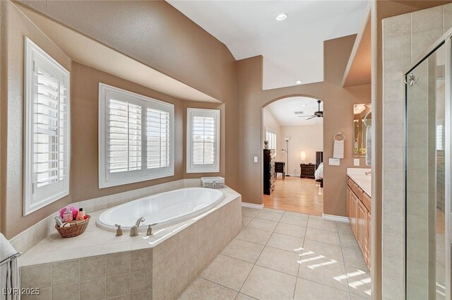 bathroom featuring tile patterned flooring, vanity, ceiling fan, and separate shower and tub