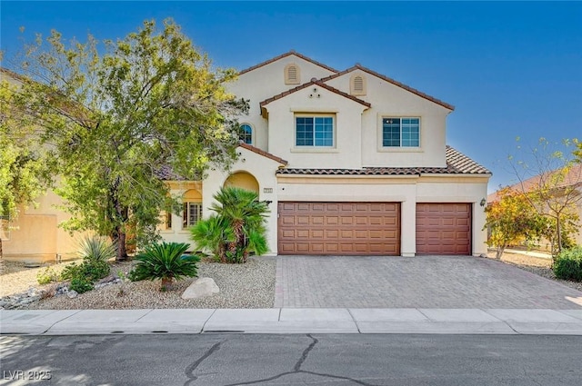 mediterranean / spanish house with a garage