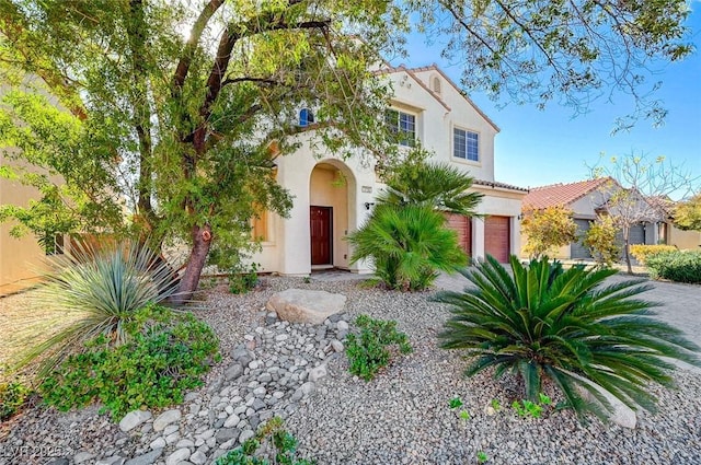 mediterranean / spanish-style home with a garage