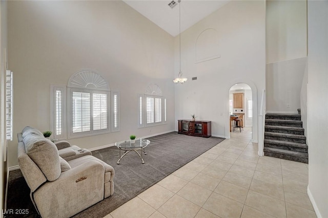 living room featuring light tile patterned floors and high vaulted ceiling