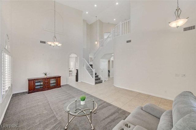 tiled living room featuring a high ceiling