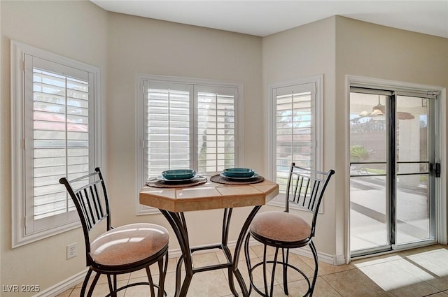 dining room with light tile patterned floors and a wealth of natural light