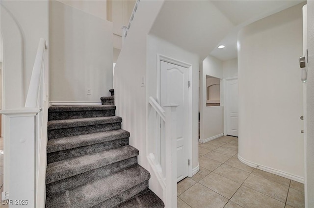 staircase featuring tile patterned floors