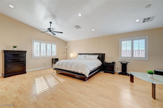 bedroom with ceiling fan, lofted ceiling, and light hardwood / wood-style flooring