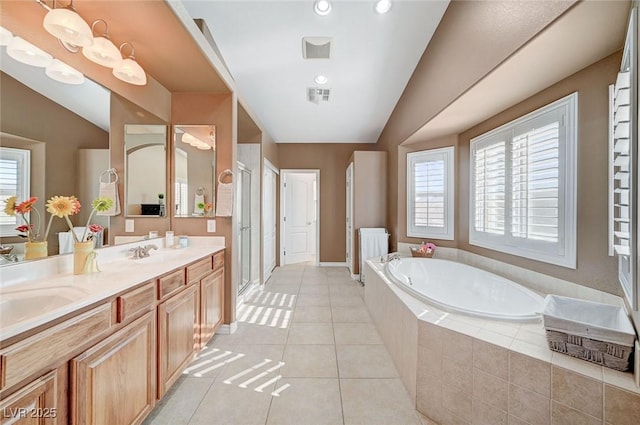 bathroom with tile patterned flooring, shower with separate bathtub, vanity, and lofted ceiling