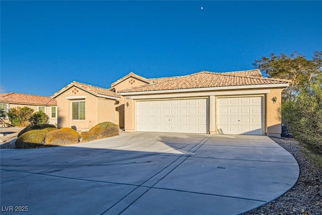 mediterranean / spanish-style home with a garage