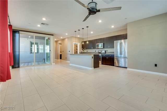 kitchen with pendant lighting, a center island with sink, sink, ceiling fan, and stainless steel appliances