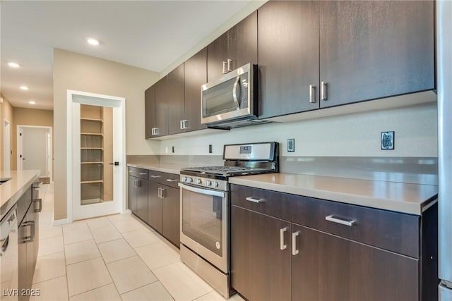 kitchen featuring dark brown cabinetry, light tile patterned floors, and appliances with stainless steel finishes