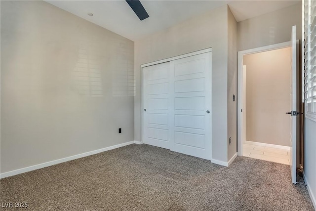 unfurnished bedroom featuring ceiling fan, carpet floors, and a closet