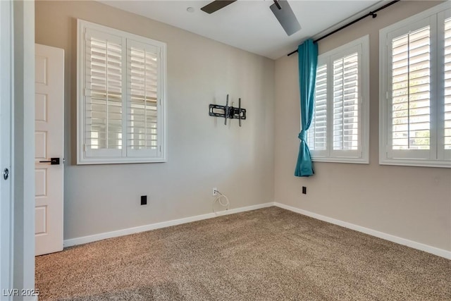 carpeted spare room with ceiling fan