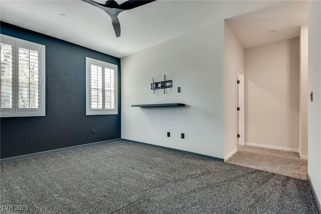 carpeted spare room with ceiling fan