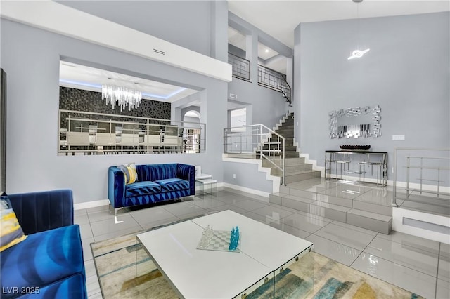 tiled living room with a towering ceiling and a notable chandelier