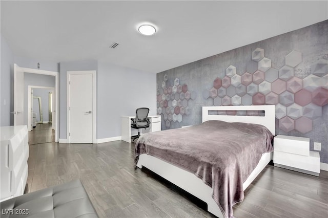 bedroom featuring hardwood / wood-style flooring and tile walls