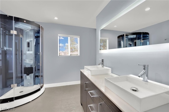 bathroom with a shower with door and vanity