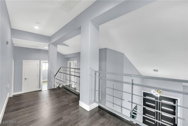 interior space featuring dark hardwood / wood-style floors and vaulted ceiling