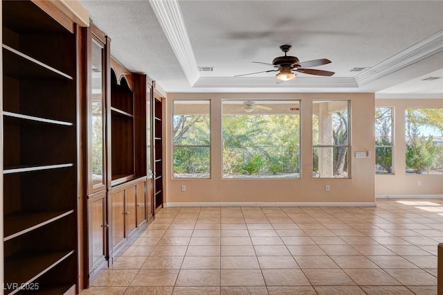 interior space with a raised ceiling and ceiling fan