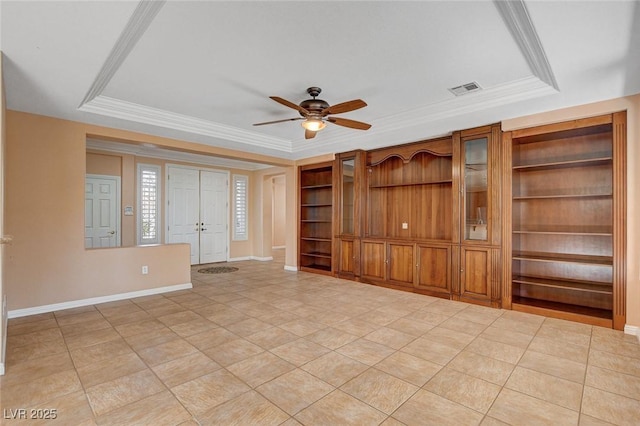 unfurnished living room featuring ornamental molding, built in shelves, a tray ceiling, ceiling fan, and light tile patterned flooring