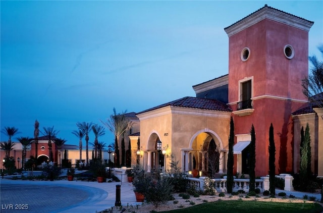 view of outdoor building at dusk